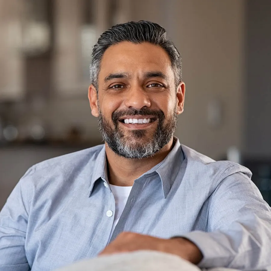 a man with a beard smiling