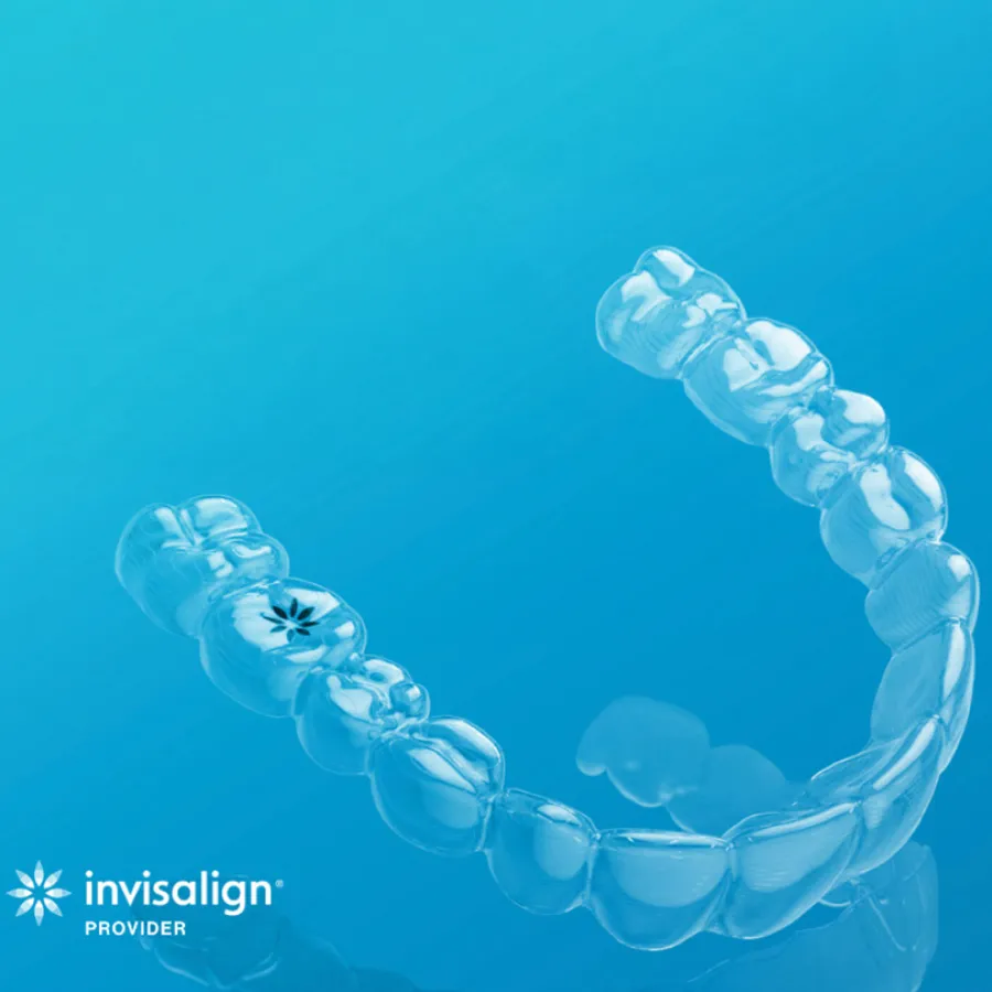 Clear Invisalign aligner against a blue background with Invisalign provider logo visible.