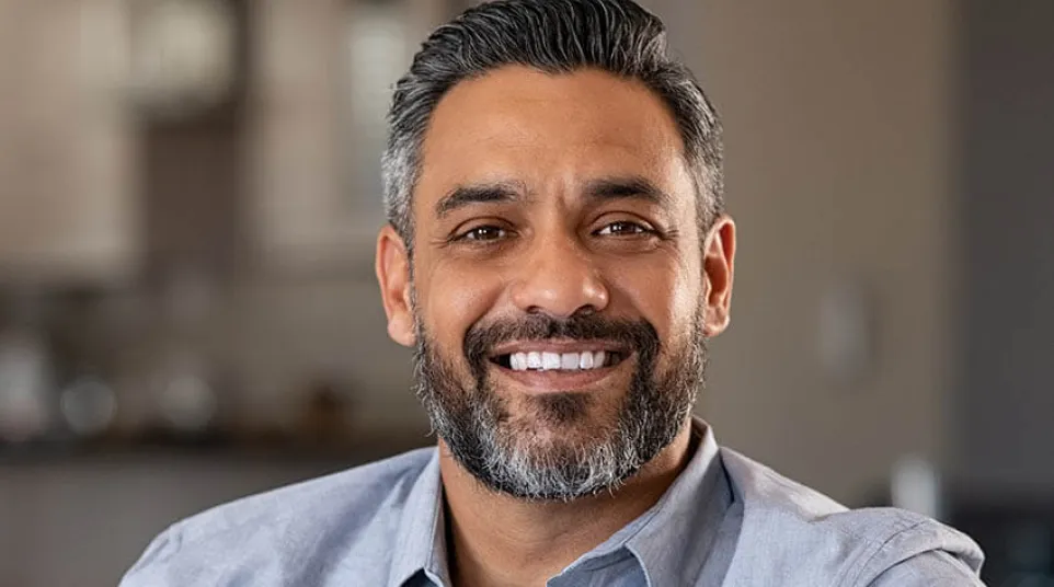 a man with a beard smiling