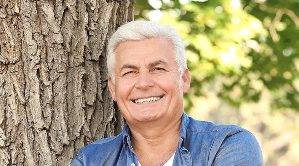 a person leaning against a tree