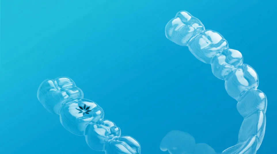 Clear Invisalign aligner against a blue background with Invisalign provider logo visible.