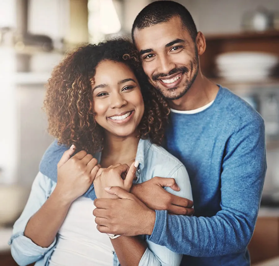a man and woman holding each other